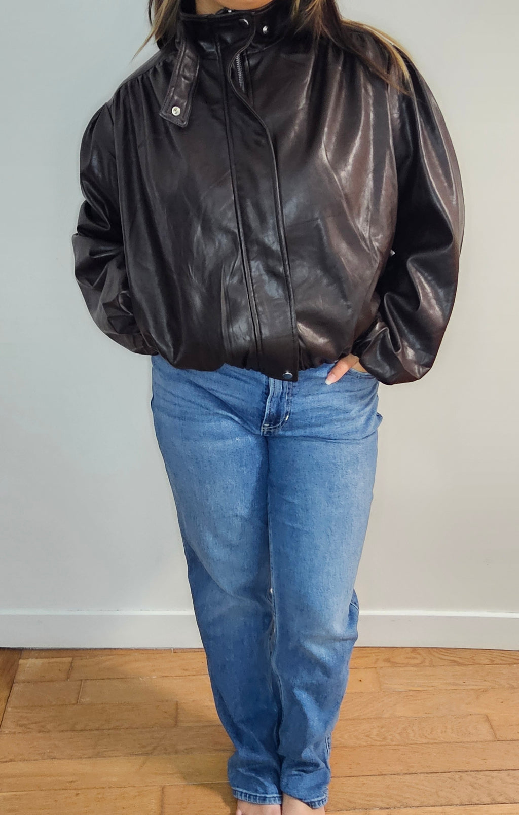 Veste bomber simili cuir oversize noire portée avec un jean mom bleu clair